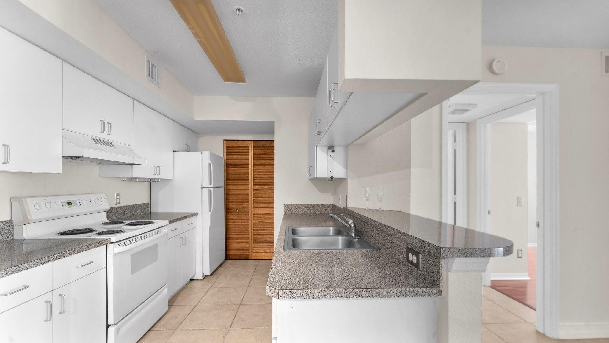 430 South Park Road, Unit 3303 Hollywood, FL 33021 - Photo 6 of 27 a kitchen with a sink stove and cabinets