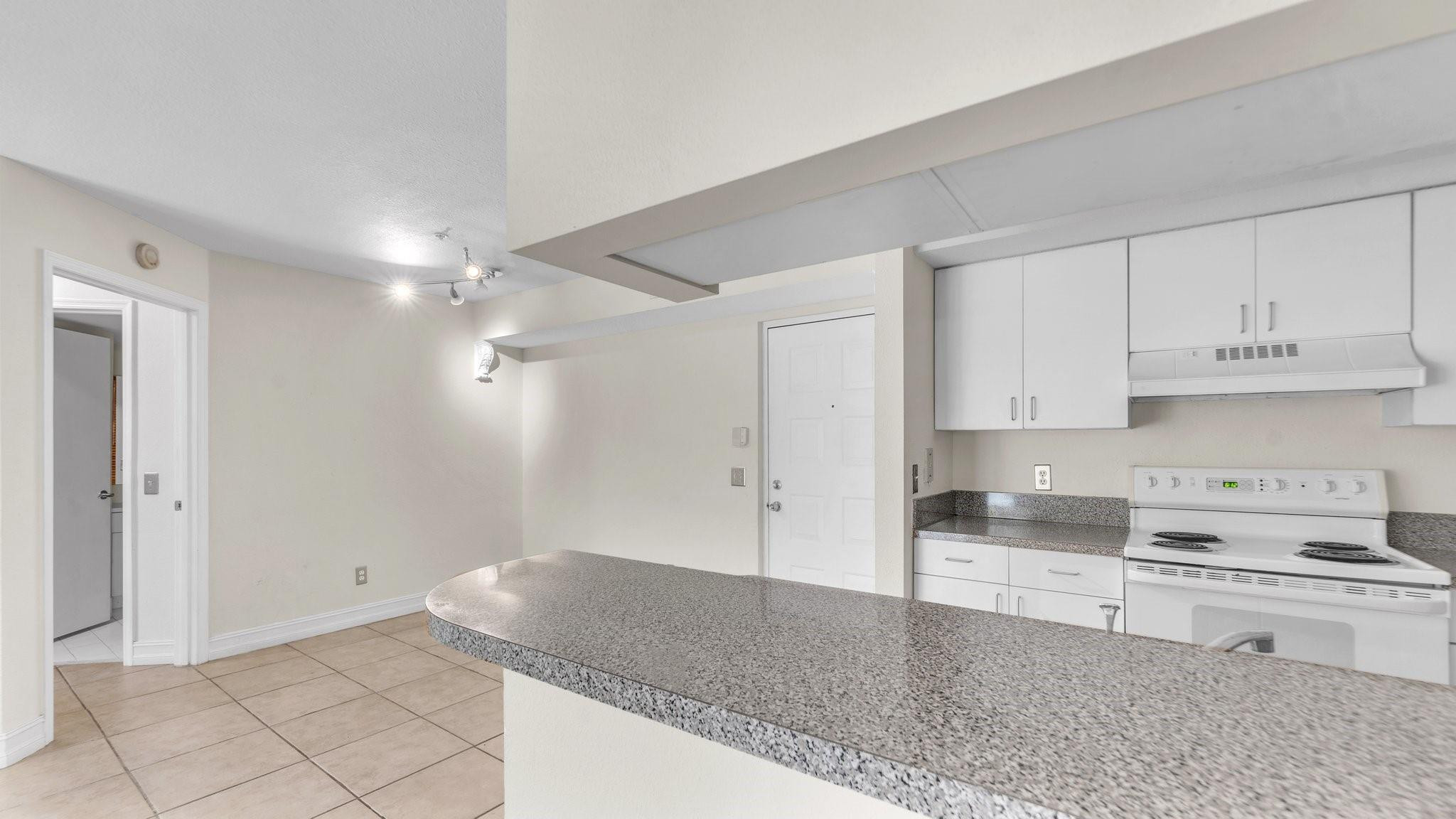 430 South Park Road, Unit 3303 Hollywood, FL 33021 - Photo 10 of 27 a kitchen with granite countertop a stove a sink and a refrigerator