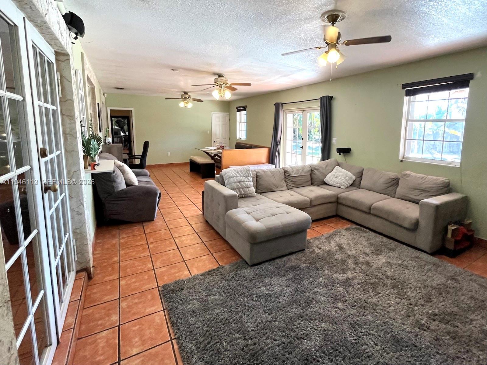 16200 Southwest 284th Street Homestead, FL 33033 - Photo 12 of 23 a living room with furniture and a flat screen tv