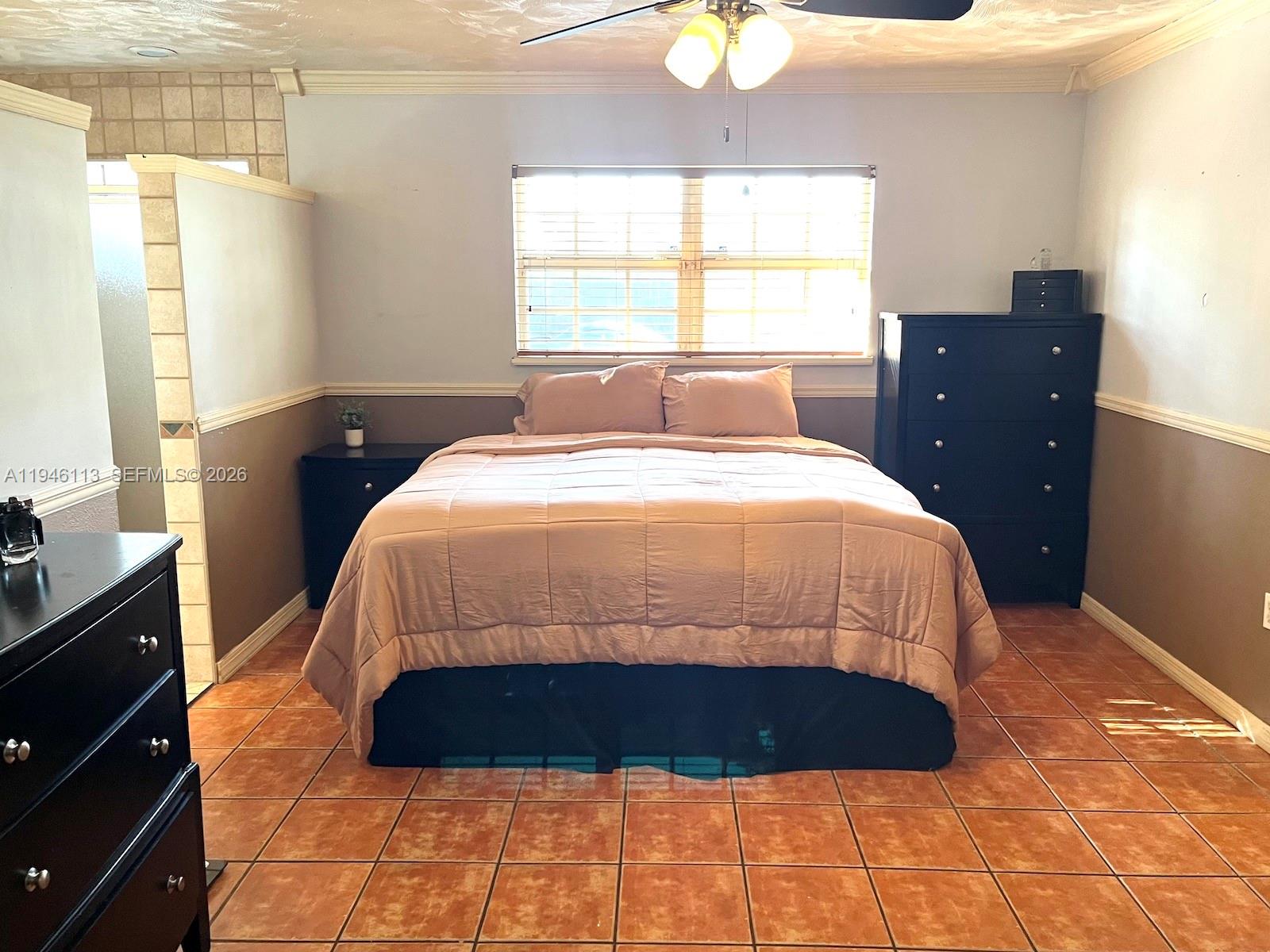 16200 Southwest 284th Street Homestead, FL 33033 - Photo 13 of 23 a large bed sitting in a bedroom next to a window