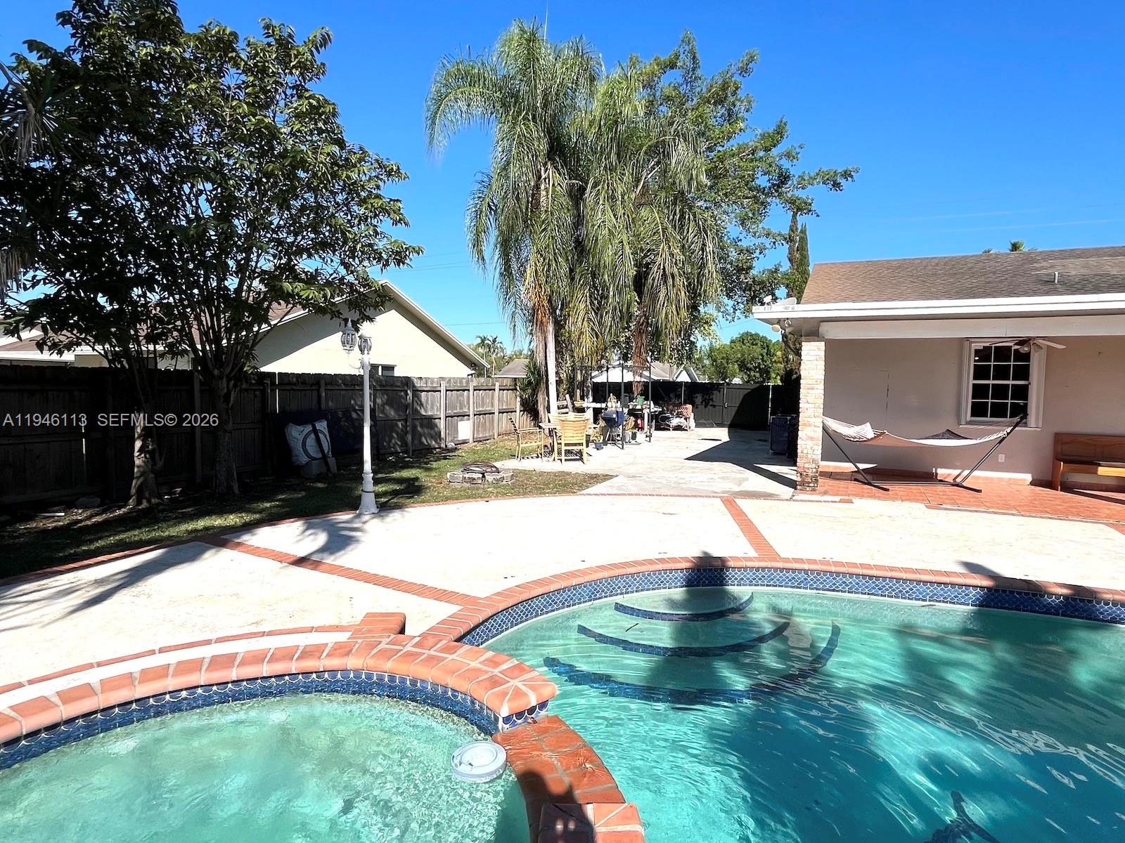 16200 Southwest 284th Street Homestead, FL 33033 - Photo 19 of 23 a swimming pool with outdoor seating and yard