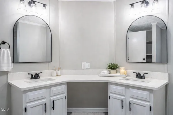 a bathroom with a double vanity sink and a mirror