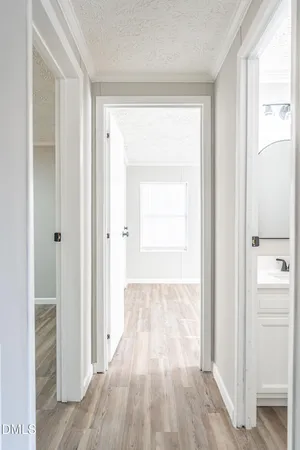 a view of a hallway with wooden floor and closet area