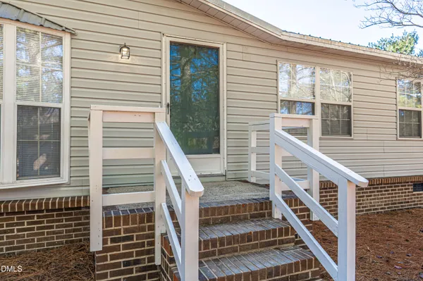 a view of a balcony with wooden floor and fence