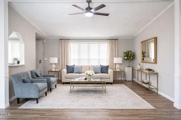 a living room with furniture and a wooden floor