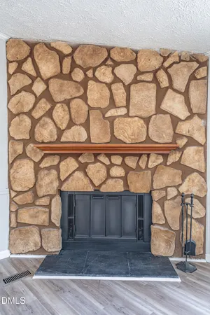 a view of a wooden door with a bench and a wooden floor