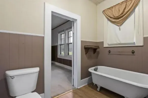 a bathroom with a toilet a sink and mirror
