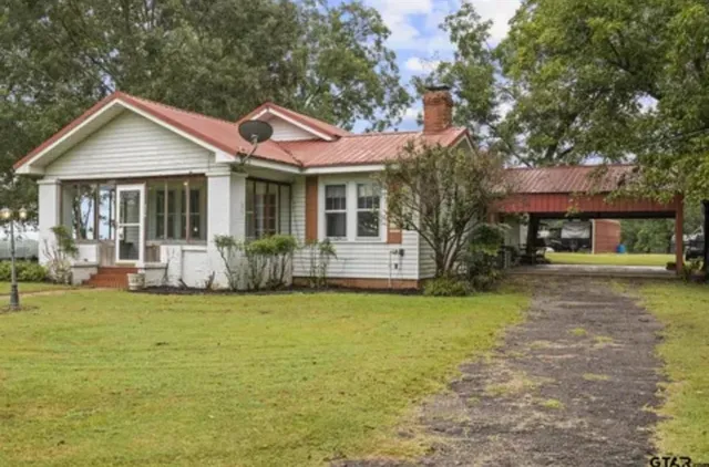 a front view of a house with a garden and porch