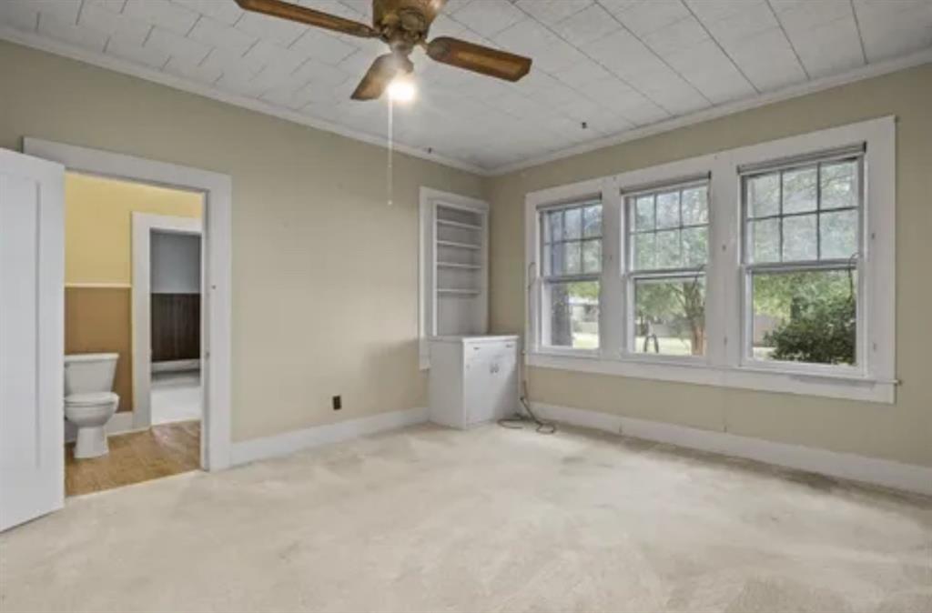 304 Daingerfield Street Naples, TX 75568 - Photo 23 of 25 en empty room with windows and chandelier fan