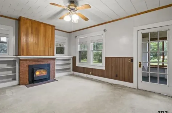 a view of livingroom with furniture fireplace and window