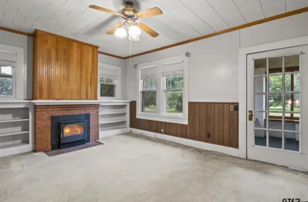 304 Daingerfield Street Naples, TX 75568 - Photo 6 of 25 wooden floor fireplace and windows in an empty room