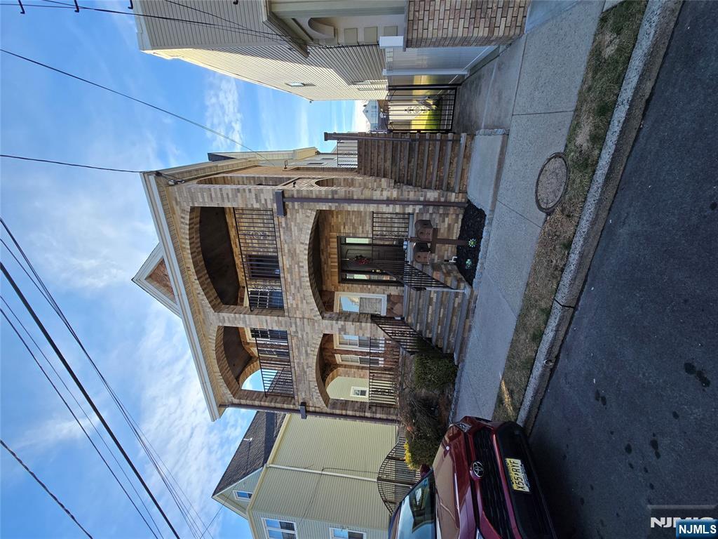 124 Devon Terrace, Unit SECOND Kearny, NJ 07032 - Photo 1 of 12 a front view of a house with parking space