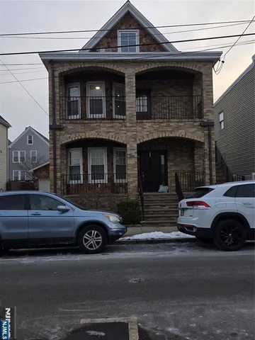 a front view of a house with parking space and a parking space