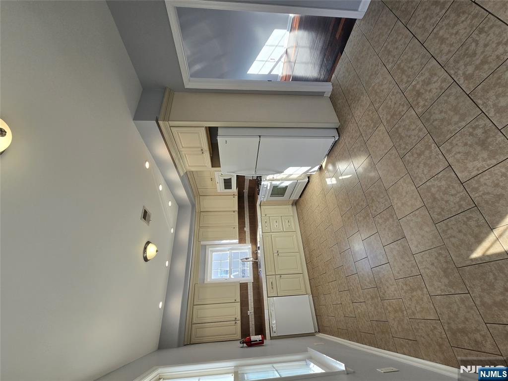 124 Devon Terrace, Unit SECOND Kearny, NJ 07032 - Photo 5 of 12 a view of a kitchen with a sink and an open refrigerator