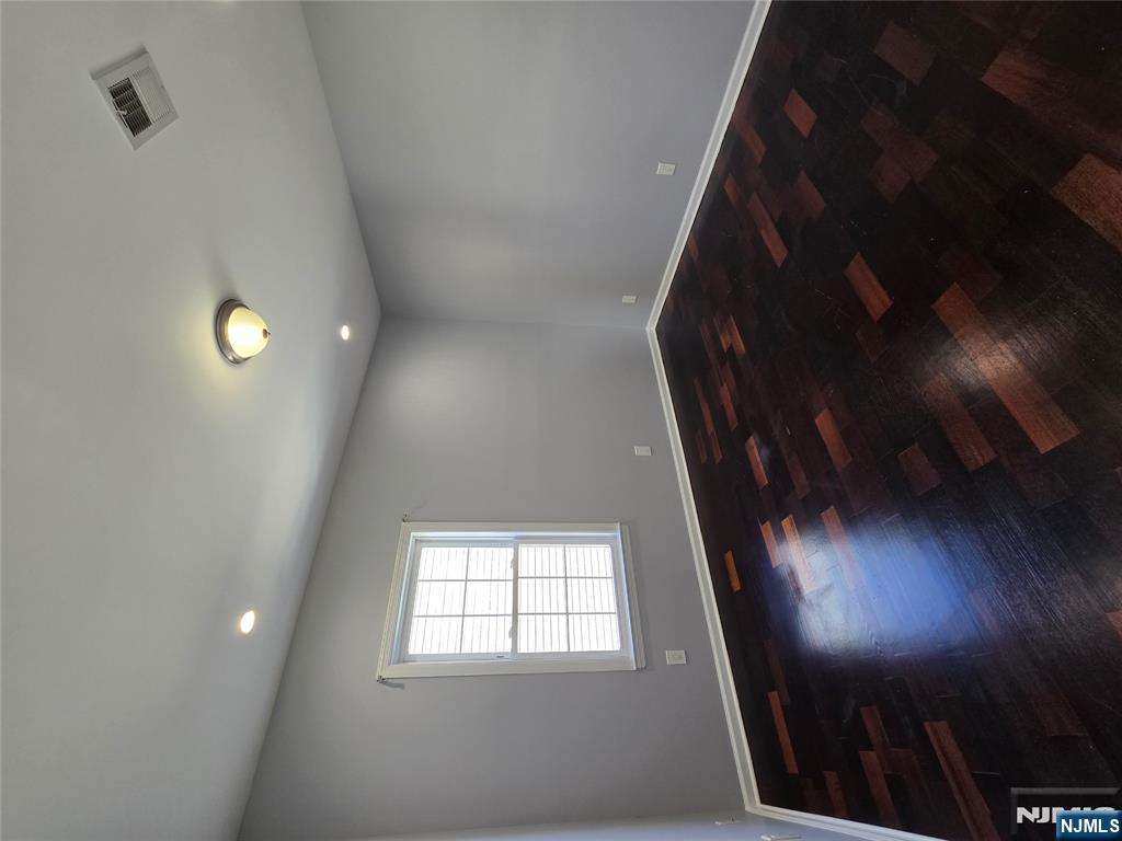 124 Devon Terrace, Unit SECOND Kearny, NJ 07032 - Photo 6 of 12 an empty room with wooden floor and windows