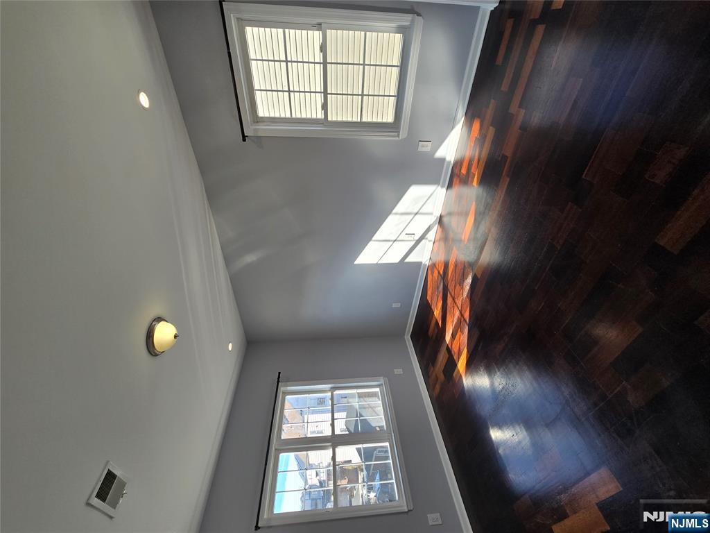 124 Devon Terrace, Unit SECOND Kearny, NJ 07032 - Photo 7 of 12 a view of empty room with wooden floor and fan