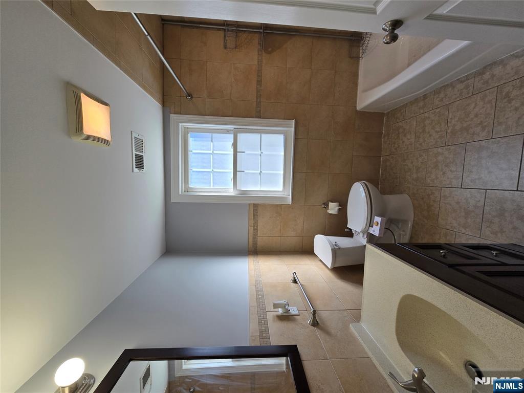 124 Devon Terrace, Unit SECOND Kearny, NJ 07032 - Photo 8 of 12 a bathroom with a sink and a mirror