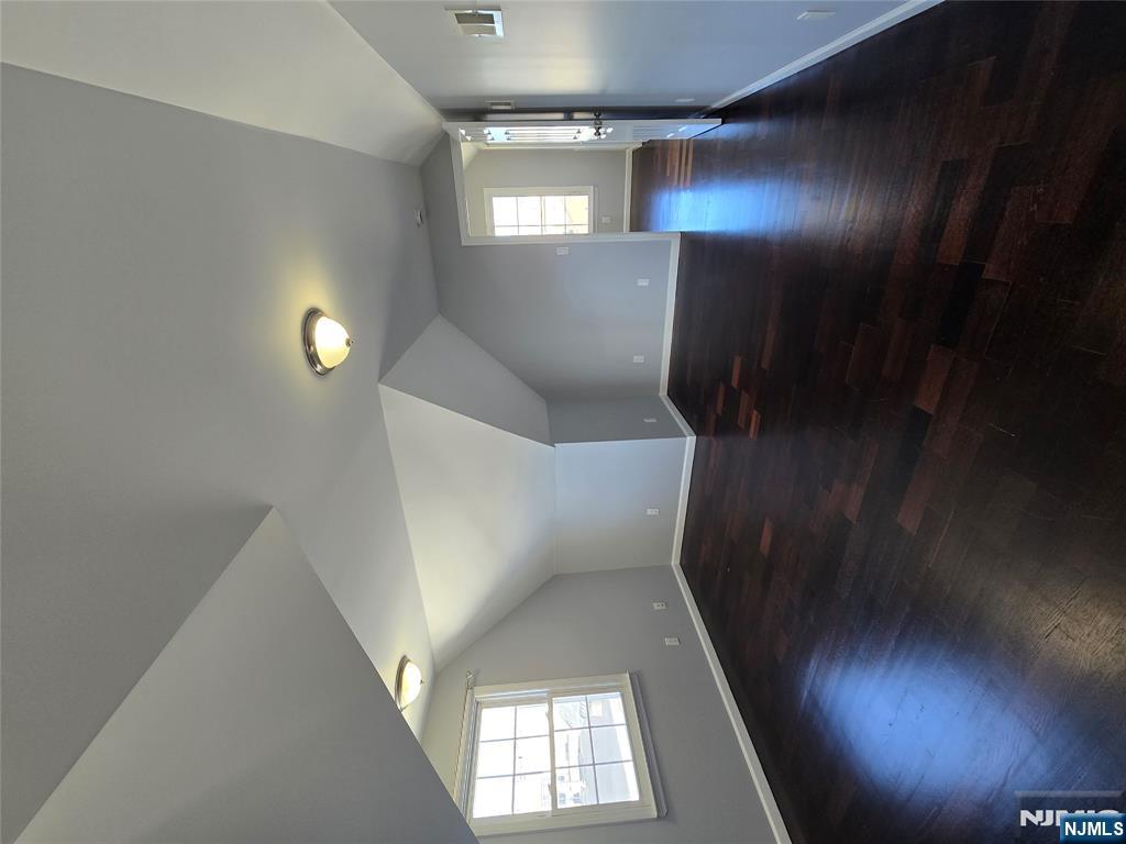 124 Devon Terrace, Unit SECOND Kearny, NJ 07032 - Photo 9 of 12 an empty room with wooden floor and windows