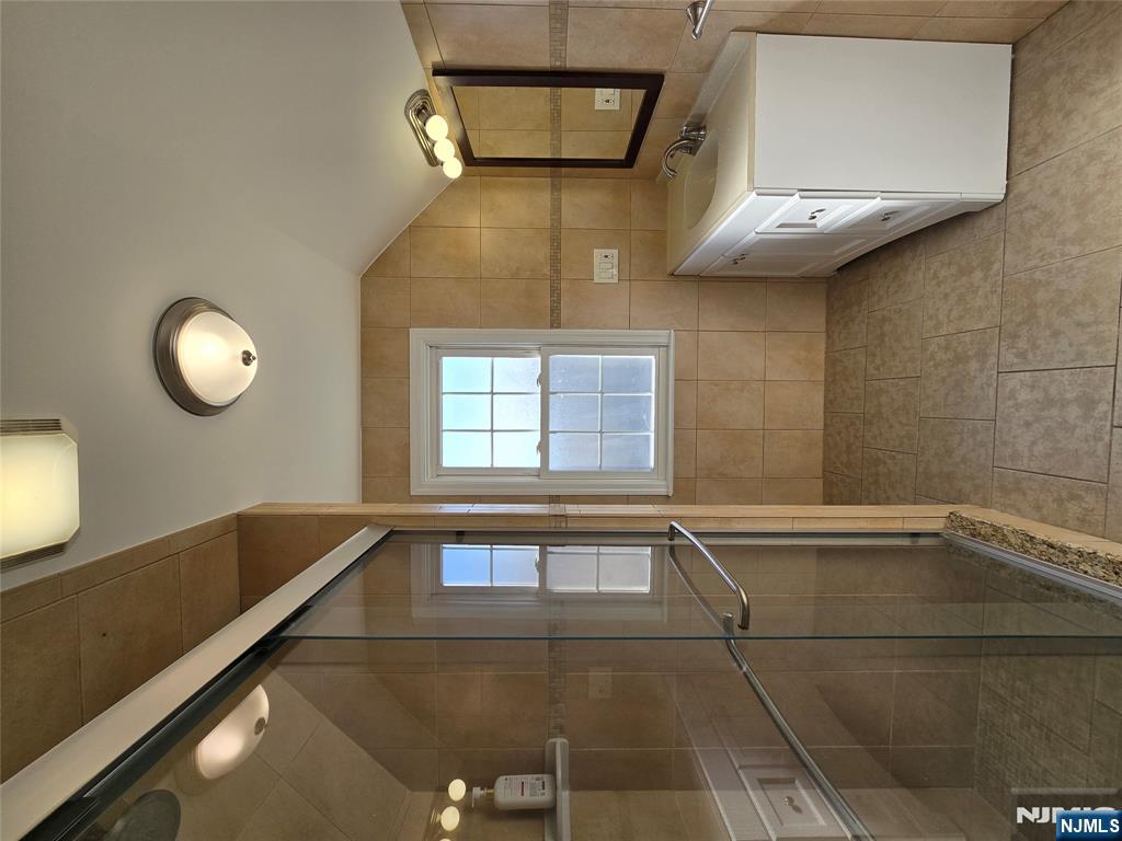 124 Devon Terrace, Unit SECOND Kearny, NJ 07032 - Photo 10 of 12 a bathroom with a sink a toilet and mirror