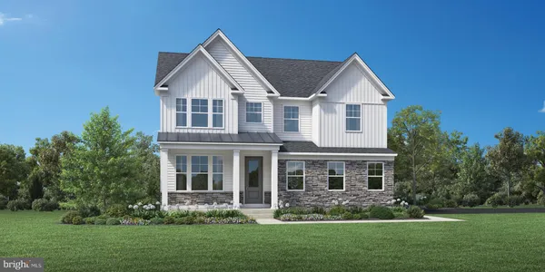 a front view of a house with a yard and green space