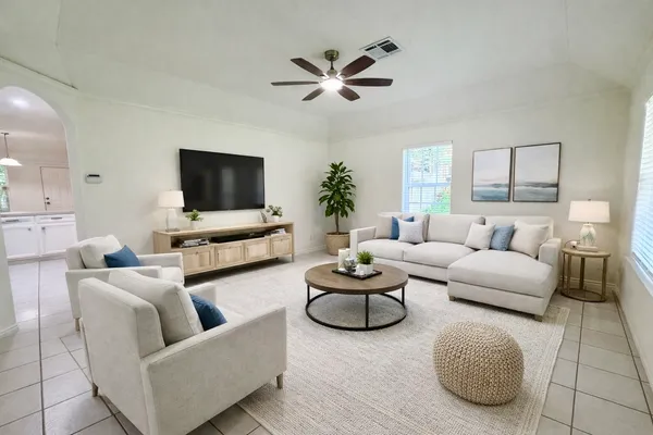 a living room with furniture and a flat screen tv