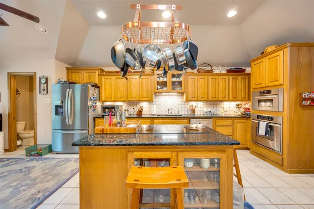 a kitchen with stainless steel appliances granite countertop a sink and cabinets