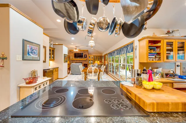 a kitchen with a stove and a dining table
