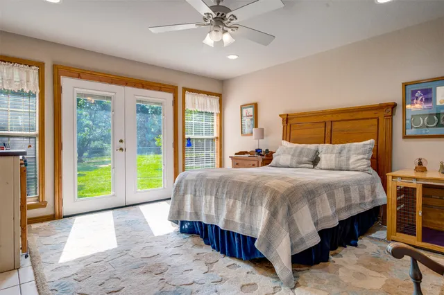 a bed sitting in a spacious bedroom next to a window