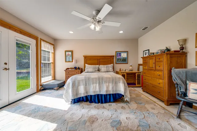 a bedroom with a large bed and a large window