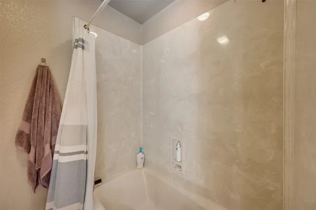 a bathroom with a bathtub and a shower