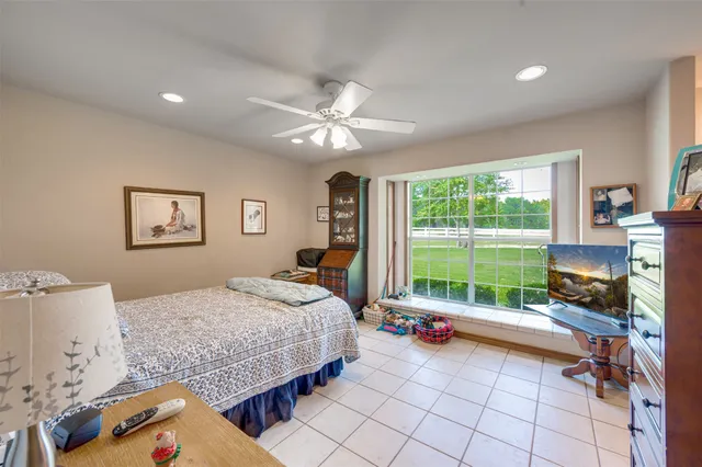 a bedroom with furniture and a large window