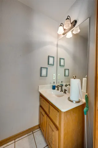 a bathroom with a sink vanity and a mirror