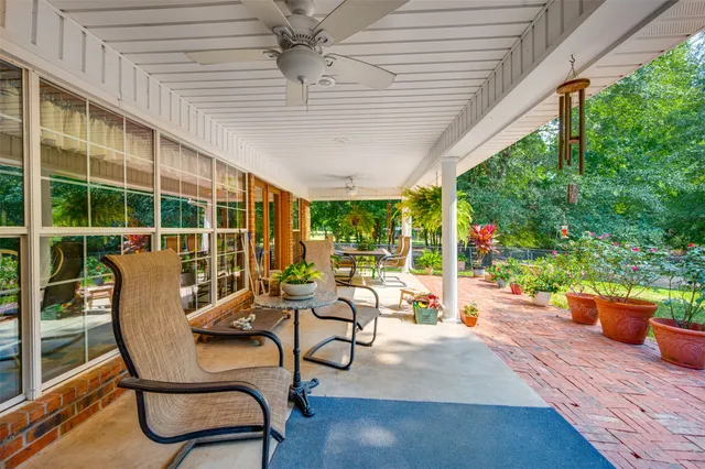 a view of a patio with table and chairs and potted plants