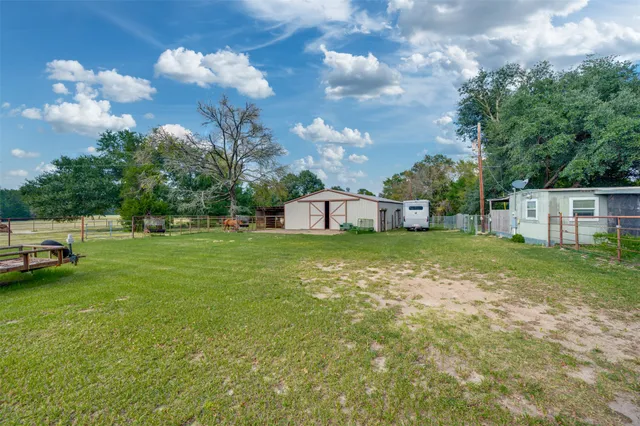 a view of a house with a backyard