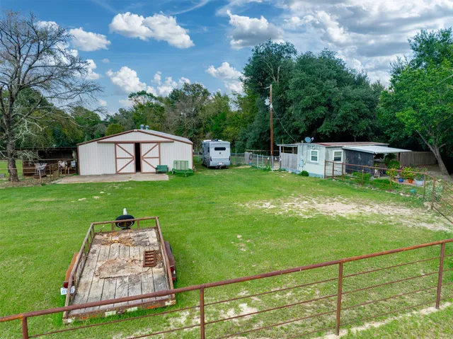 a house with green field in front of it
