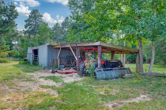 a view of a chair and table in backyard of the house