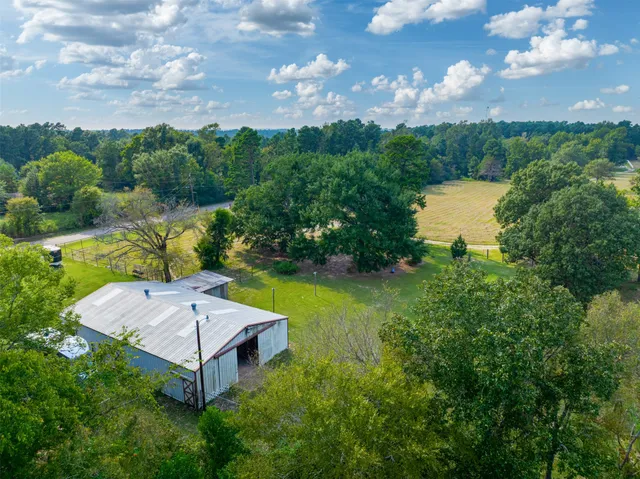 an aerial view of a house with garden space and street view
