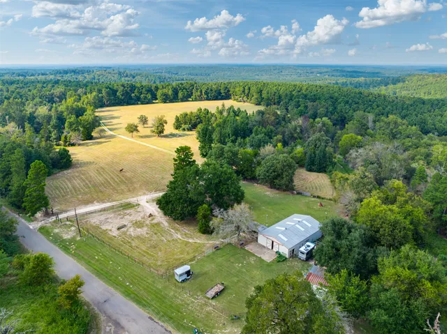 a view of a water pond with green field