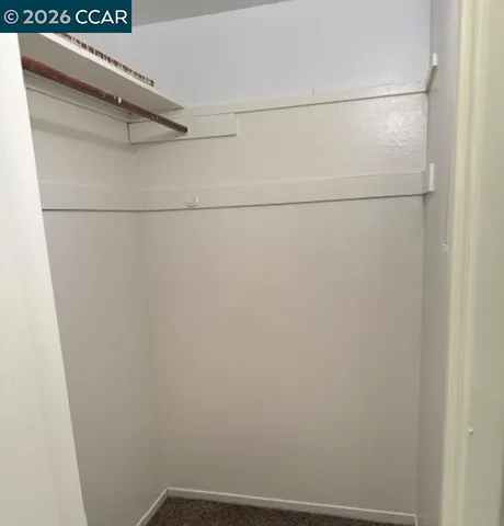 a view of a yard with plants and wooden fence