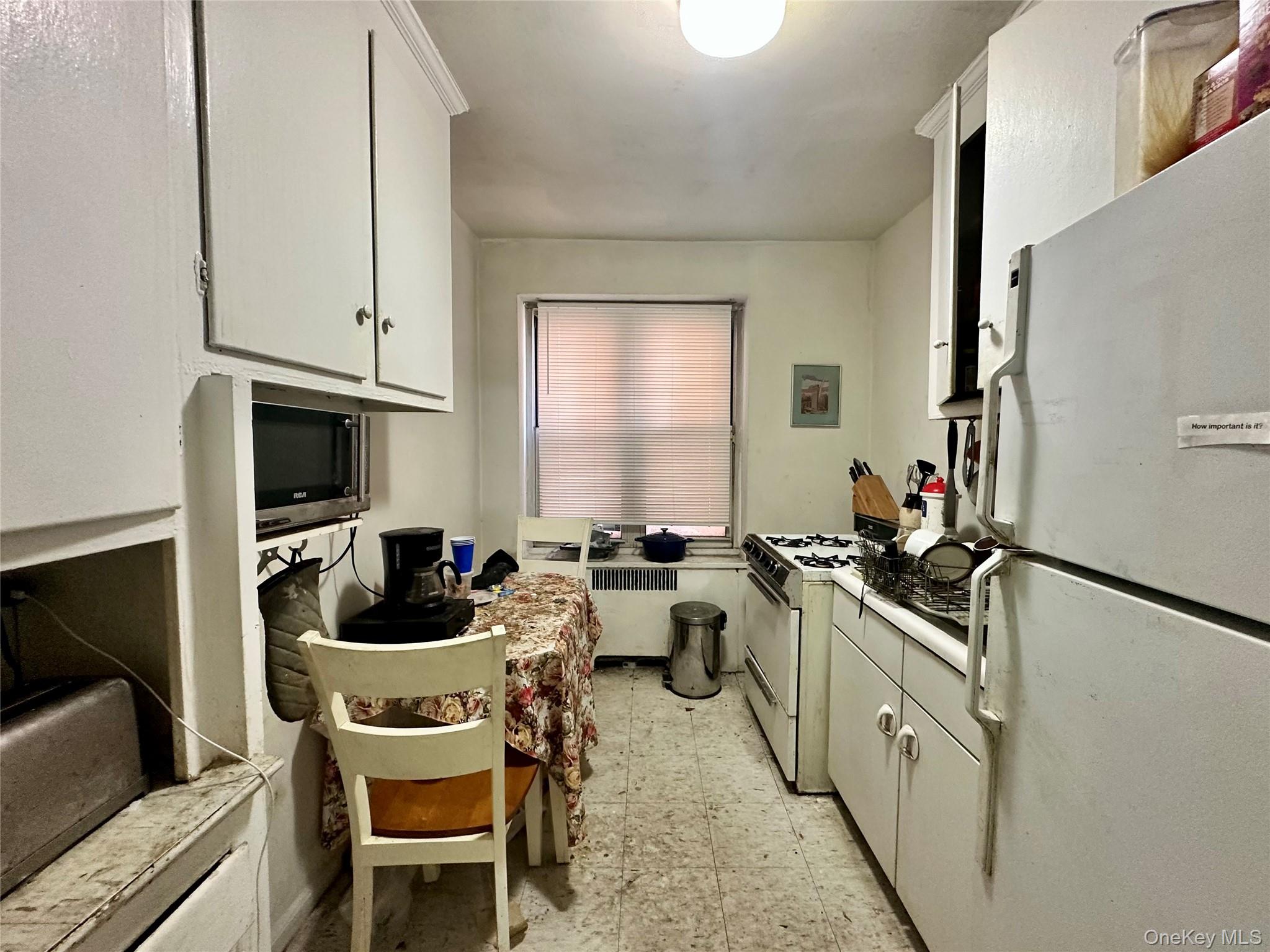 111-50 75th Road, Unit 1A Queens, NY 11375 - Photo 5 of 9 a kitchen that has a sink and chairs