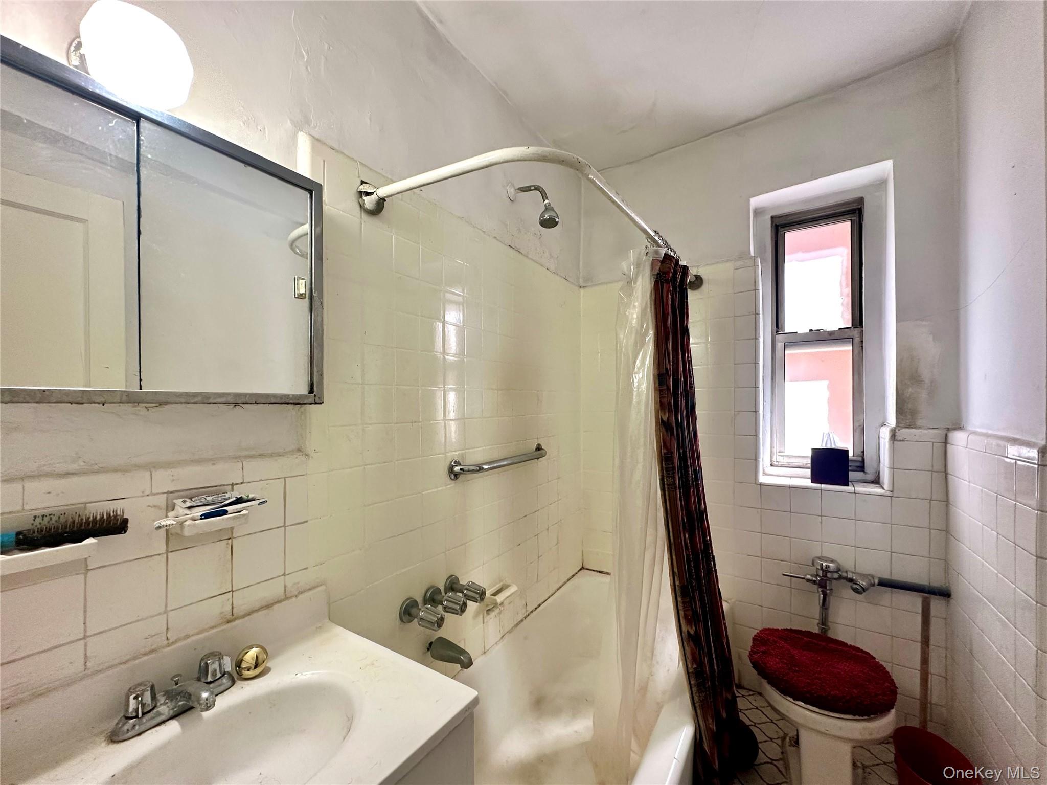 111-50 75th Road, Unit 1A Queens, NY 11375 - Photo 7 of 9 a bathroom with a sink a toilet a mirror and shower