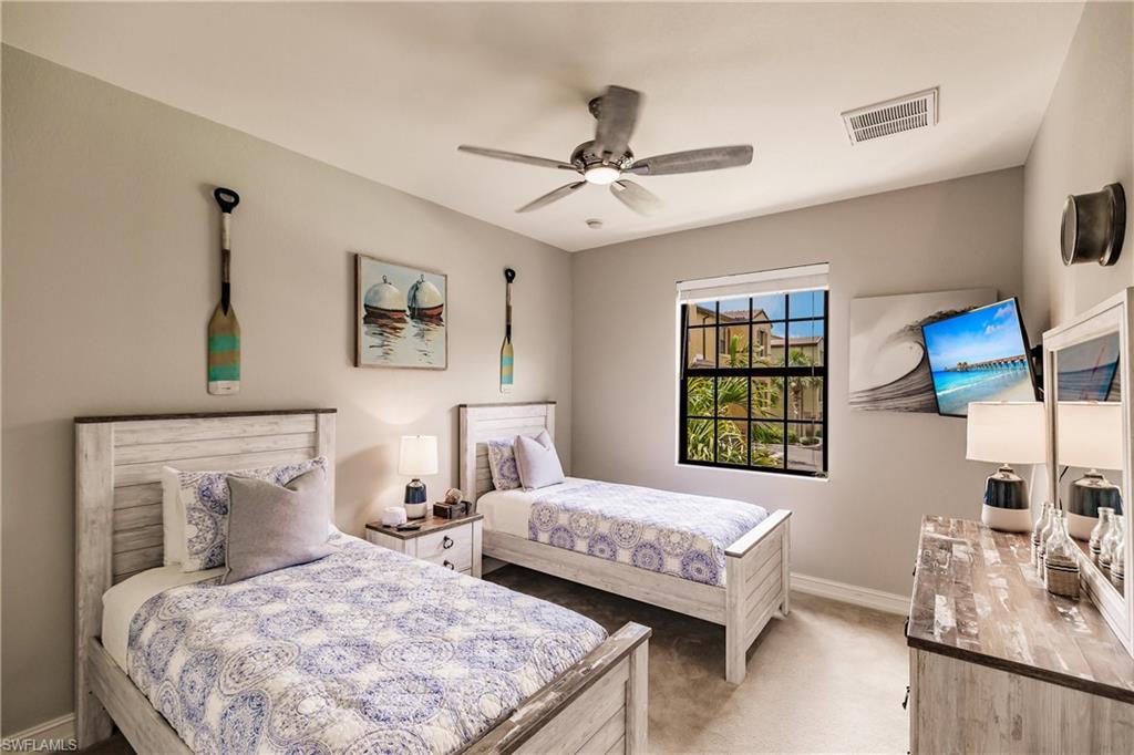 9081 Albion Lane South, Unit 6502 Naples, FL 34113 - Photo 18 of 37 a bedroom with two beds and a window