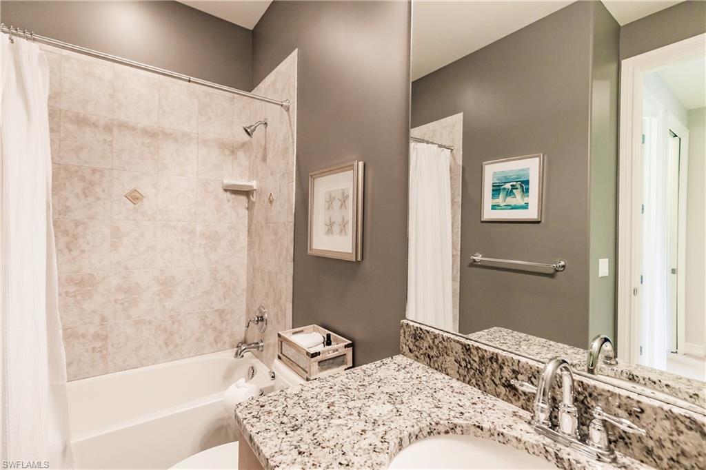 9081 Albion Lane South, Unit 6502 Naples, FL 34113 - Photo 19 of 37 a bathroom with a bathtub and a shower