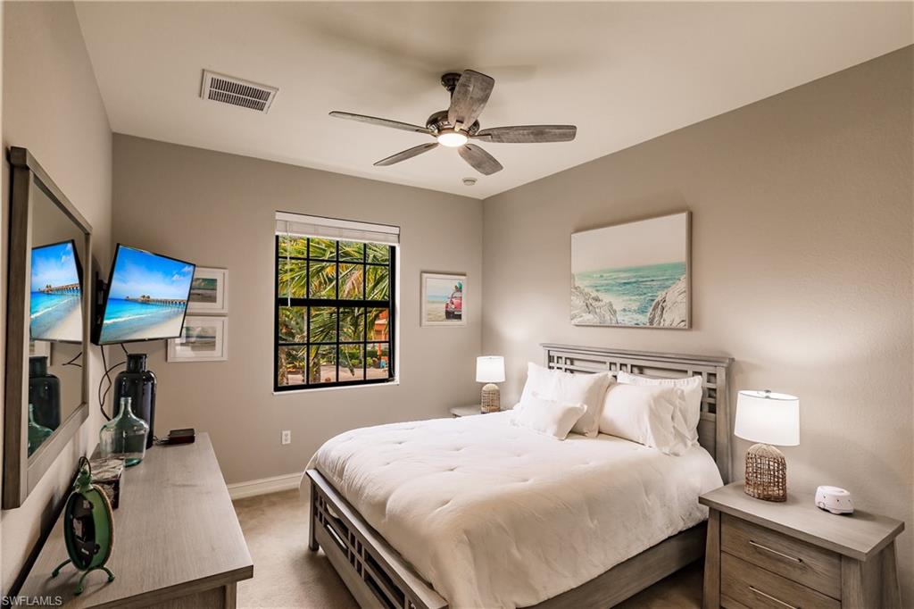 9081 Albion Lane South, Unit 6502 Naples, FL 34113 - Photo 20 of 37 a bedroom with bed and window