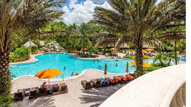 a view of a swimming pool with an outdoor seating and a yard