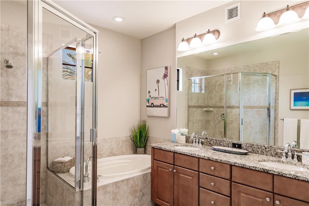 9081 Albion Lane South, Unit 6502 Naples, FL 34113 - Photo 21 of 37 a bathroom with a granite countertop sink mirror and a shower