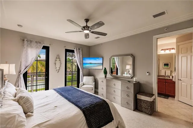 a bedroom with a balcony a large bed and a window