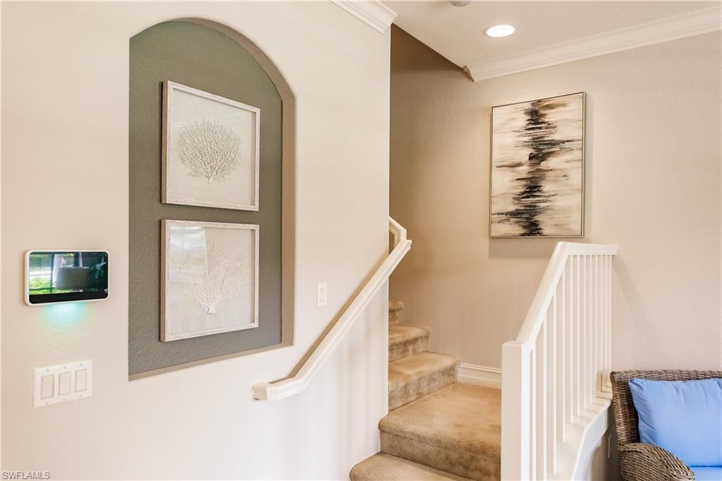 9081 Albion Lane South, Unit 6502 Naples, FL 34113 - Photo 27 of 37 a view of a hallway with stairs and furniture