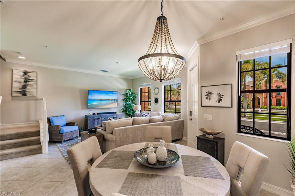 9081 Albion Lane South, Unit 6502 Naples, FL 34113 - Photo 28 of 37 a view of a dining room with furniture a chandelier and large window