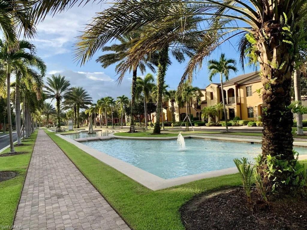 9081 Albion Lane South, Unit 6502 Naples, FL 34113 - Photo 35 of 37 a view of swimming pool with a table and chairs
